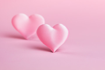 Pink silk heart on a pink background. The concept of minimalism. Place for text. Pastel colors .