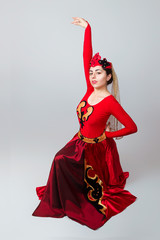 Armenian girl in national costume dancing a folk dance.