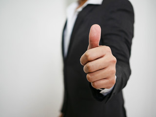 Businessman showing thumbs up sign