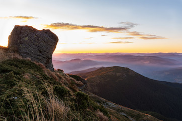 Sunrise over the cliff. The sun is hidden behind the mountain.