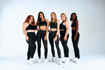 Fototapeta premium Models with diversuty in skin, hair. African, american, european cheerful emotional posing on white background. Models, trends