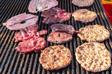 Pieces of grilled meat cooked on the grill