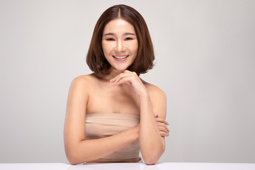 Fototapeta na wymiar Beautiful Young Asian Woman with short hair Looking While Touching Chin feeling so happy and cheerful with healthy Clean and Fresh skin,isolated on white background,Beauty Cosmetics Concept