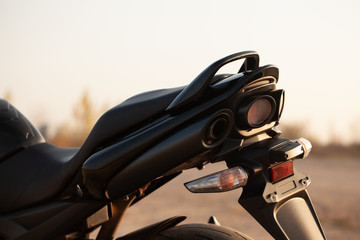 One black motorcycle in the desert.