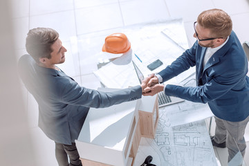 business people shaking hands in the architectural office.