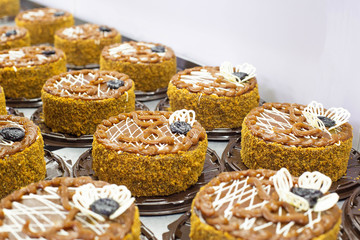 Making delicious chocolate biscuit cakes with condensed milk and prunes in the confectionery industry. Making desserts and sweets, torte, background