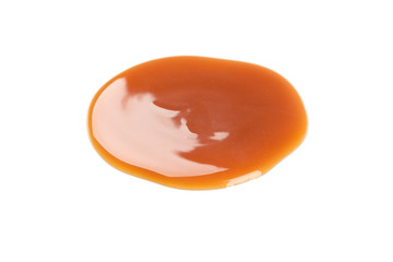 Sweet caramel sauce isolated on white background, close up