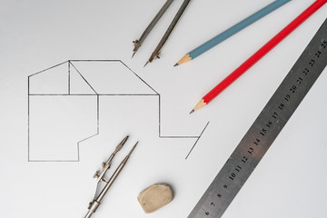 drawing a plan on a color surface using the pencil, ruler, compass and other tools, geometry shapes