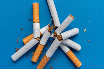 a no tobacco day, a broken cigarette on color background isolated on color surface, stop smoking