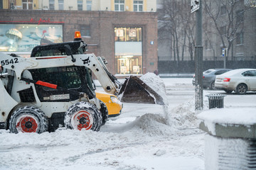 the city snow cleaning service department at work in the public streets, cold season