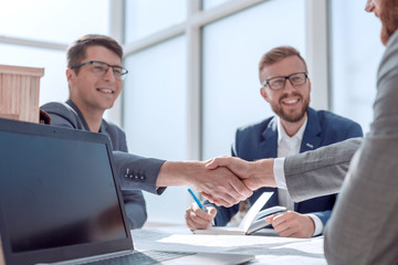 close up. business people shaking hands at a meeting in the office