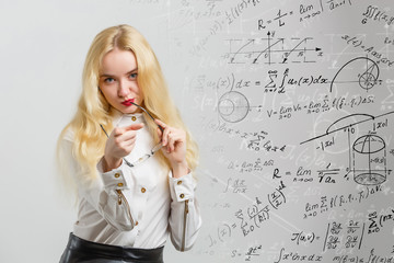 Beautiful young school girl thinking about complex mathematical signs