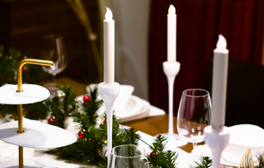 Christmas dinner, .Served dinner table. Restaurant interiore. Multicolored glass balls for happy new year.