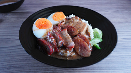 Barbecued red pork and crispy pork in sauce with rice or thai name Kao Moo Dang. Street food menu in Thailand 