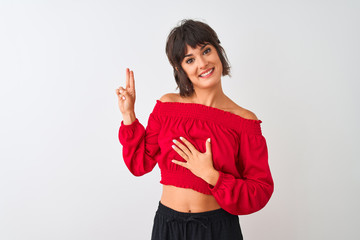 Young beautiful woman wearing red summer t-shirt standing over isolated white background smiling...