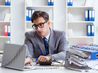 Busy employee chained to his office desk