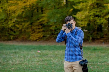 Professional photographer in action with two cameras on a shoulder straps