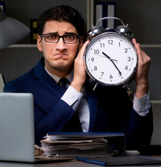 The employee staying late to finish work on auditing