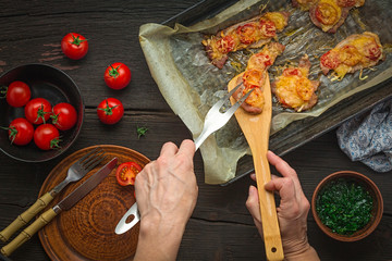 Woman cooked meat baked with sauce and cheese