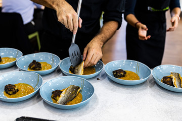 Chefs placing the menu items to their customers