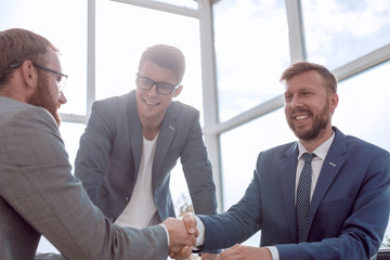 business colleagues shaking hands at a business meeting.