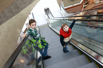 Brothers ride up escalator