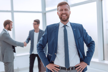 close up. successful business man standing in a bright office