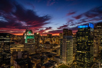 Aereal view of a deep red suset and golden lights of downtown San Francisco