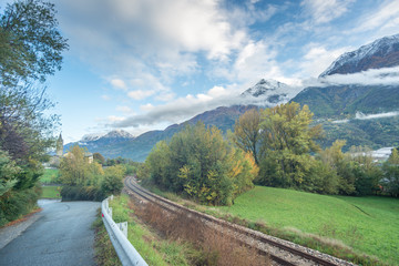 mountain panorama with first snowfall, clouds and fog