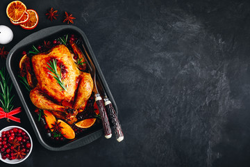 Roasted chicken or turkey with spices, oranges and cranberries for Christmas or Thanksgiving
