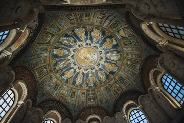 Fototapeta na wymiar RAVENNA, ITALY - September 11, 2019: Magnificent mosaic painting on the ceiling of the baptistery of Neon, built in the 5th century. Showing the Baptism of Jesus, the apostles around. South Europe.