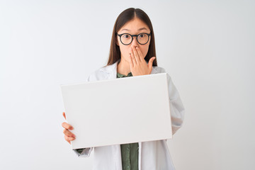 Young chinese dooctor woman wearing glasses holding banner over isolated white background cover...