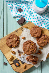 Baked christmas cookies. Homemade Chocolate chip cookies and milk on a wooden rustic table. Copy space.