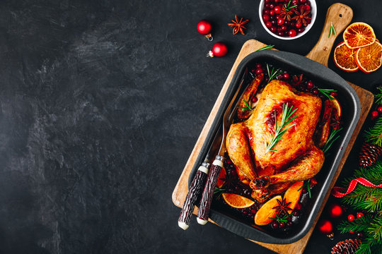 Christmas baked chicken or turkey with spices, oranges and cranberries