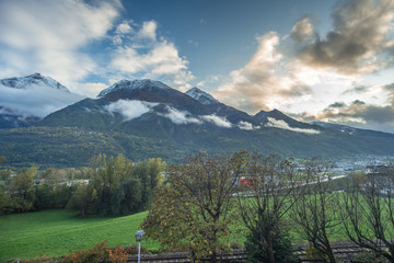 Fototapeta premium mountain panorama with first snowfall, clouds and fog
