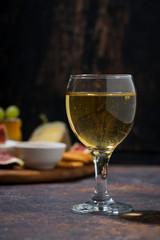 glass of white wine and snacks, closeup