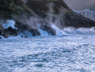 Naklejka premium Waves crashing on the rocks of a beach in Cantabria, Spain. Horizontal image.