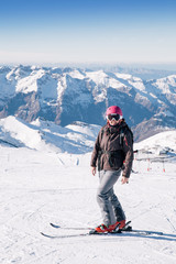 Fototapeta na wymiar Young skier woman posing for the camera on french slopes