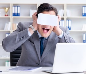 Businessman with virtual reality glasses in modern technology co