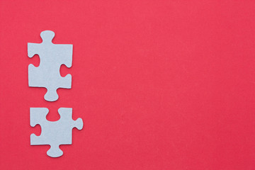 Puzzle pieces on a red background.