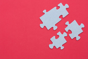 Puzzle pieces on a red background.