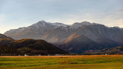 Sunrise / sunset on mountain hills of a romanian village. Bran. Brasov