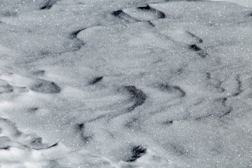 background of shiny frozen snow in a sunny day