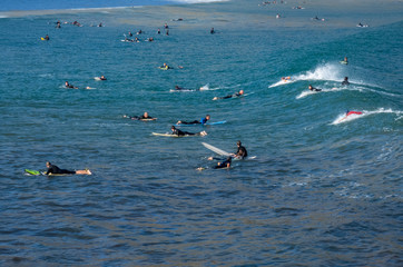 Islares, Spain , 29 September 2019 Wide surf beach of Islares with surfers waiting big  waves in Cantabria, Spain.