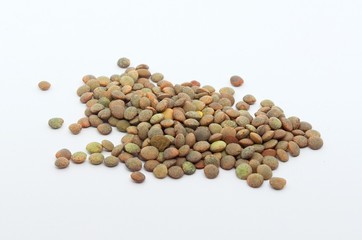 Brown lentils on an isolated white background