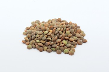 Brown lentils on an isolated white background