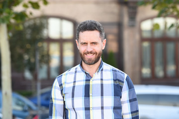 Looking great in that shirt. Mature man on urban background. Handsome mature adult in casual style....