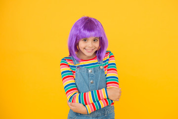 I love changing my hair. Cute little girl smile with fancy hair. Happy small child wear short hair wig. Funny kid with violet synthetic hair. Beauty and fashion