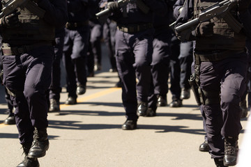 close up of the special weapon and assault officers during a parade holding their assault guns