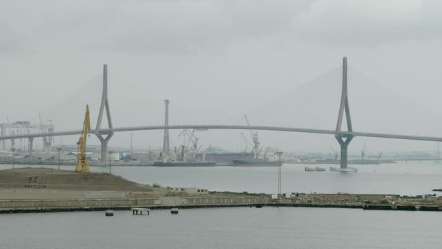 Bay of Cadiz with new construction site of the commercial port and the Constitution of 1812 Bridge or La Pepa Bridge.